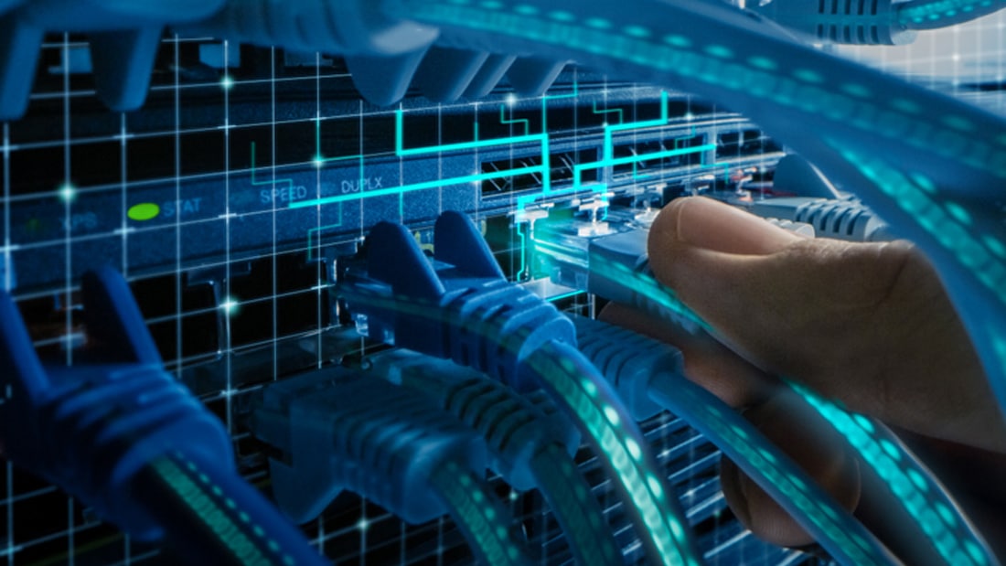 A hand plugs an Ethernet cable into a network switch, with glowing cables and a digital grid overlay representing data transfer and connectivity.
